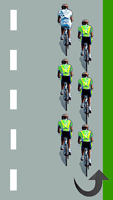 Le cycliste blanc est en tête du peloton à gauche